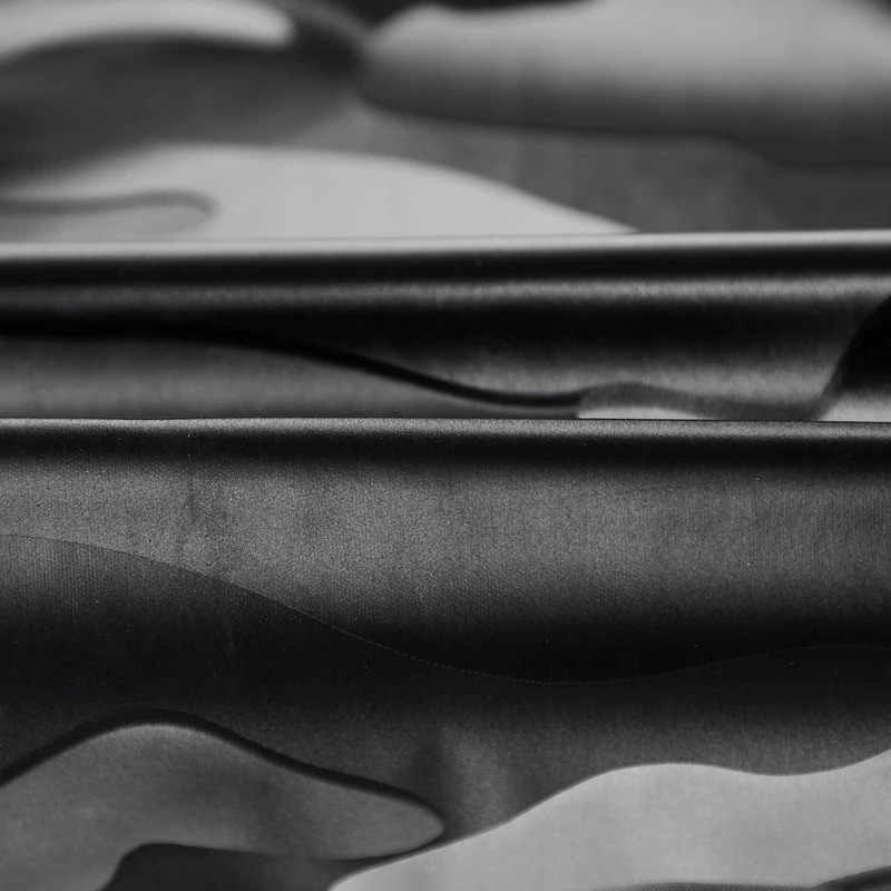 Close-up of stylish camouflage fabric for men's PU leather jacket, showcasing trendy patterns and sleek texture.