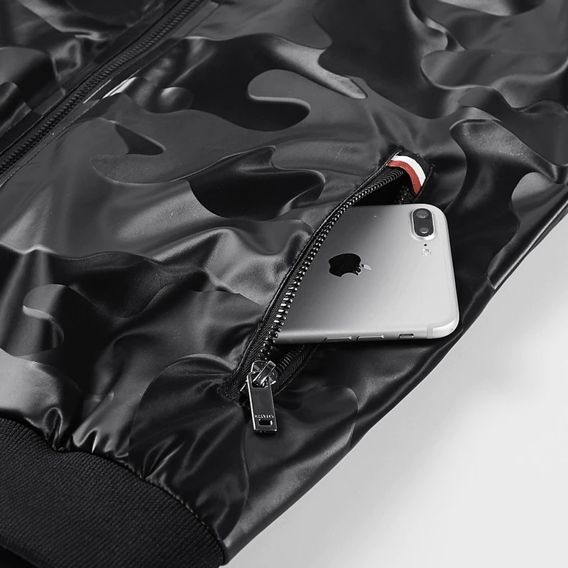 Close-up of a black camouflage PU leather jacket showcasing a pocket with a smartphone inside.