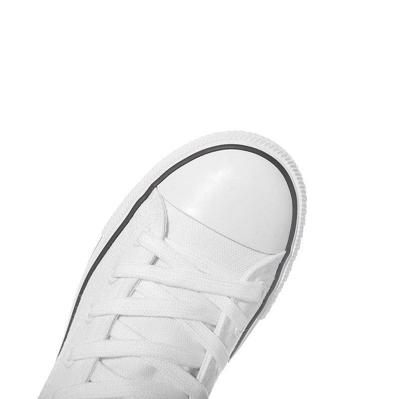 Close-up of a white lace-up canvas sneaker, perfect for a punk rock style look. Ideal for women seeking comfort and edge.