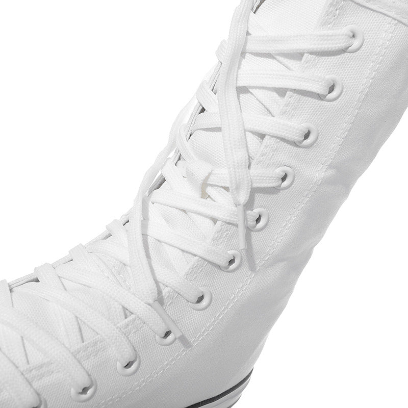 Close-up of white canvas women's lace-up mid-calf sneakers showcasing stylish laces and fabric texture for rock style.