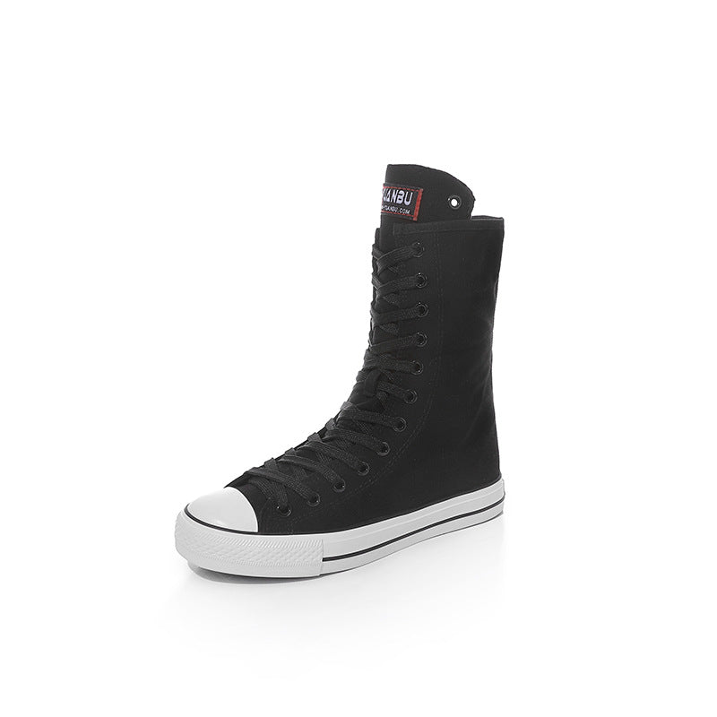 Black canvas mid-calf sneakers with lace-up design, perfect for a rock style outfit.