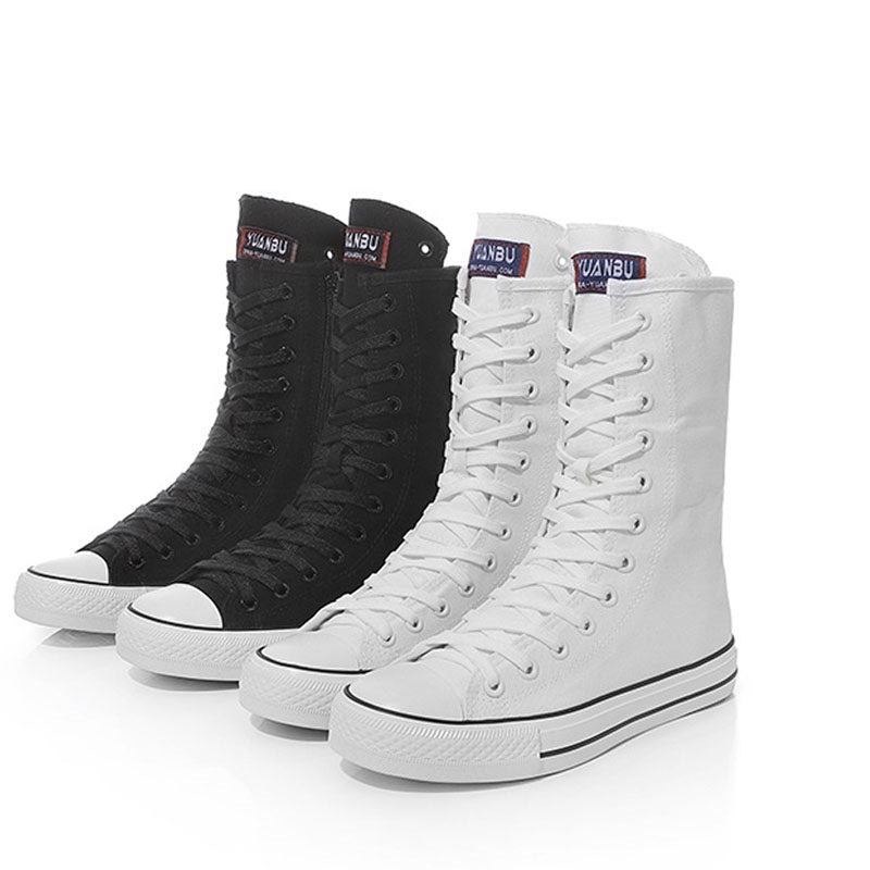 Stylish canvas mid calf sneakers in black and white, perfect for a rock grunge look. Comfortable and trendy footwear for women.