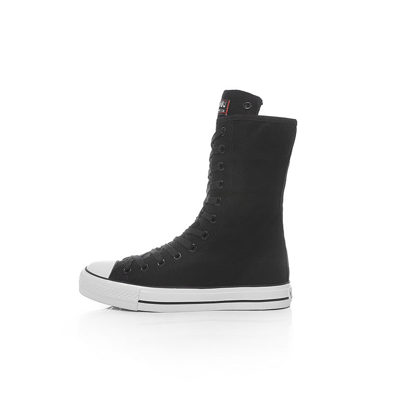 Black canvas women’s lace-up mid calf sneakers for a stylish rock vibe, perfect for grunge lovers.