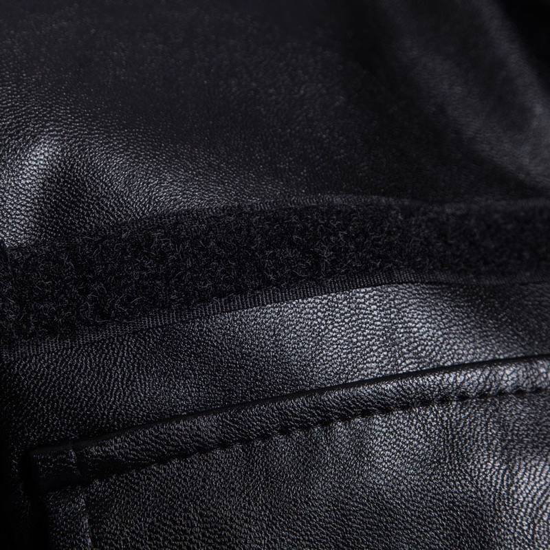 Close-up of casual men's black PU leather coat texture with zipper detail, showcasing the stylish biker design and quality material.