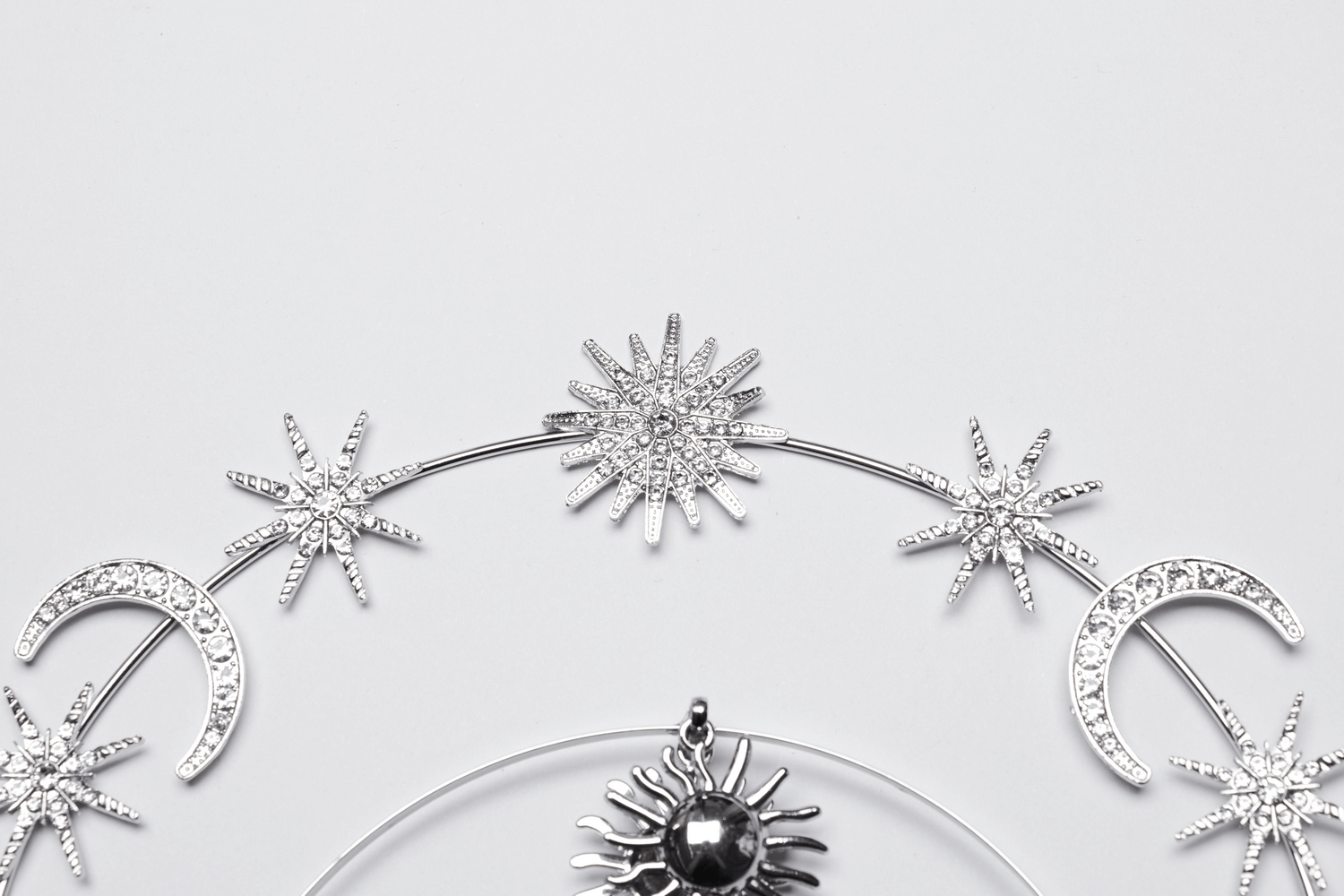 Celestial gothic headpiece with stars, moons, and a radiant sun design.