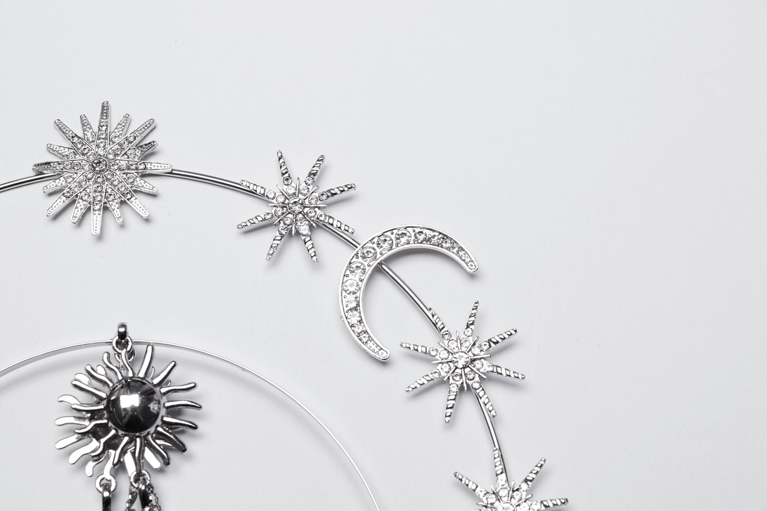 Celestial Gothic headpiece featuring stars, moons, and a sun design with sparkling diamond embellishments.