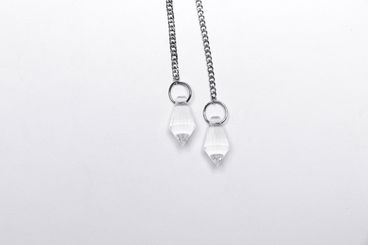 Elegant crystal water droplet pendants on silver chains, perfect for adding a celestial touch to any outfit.