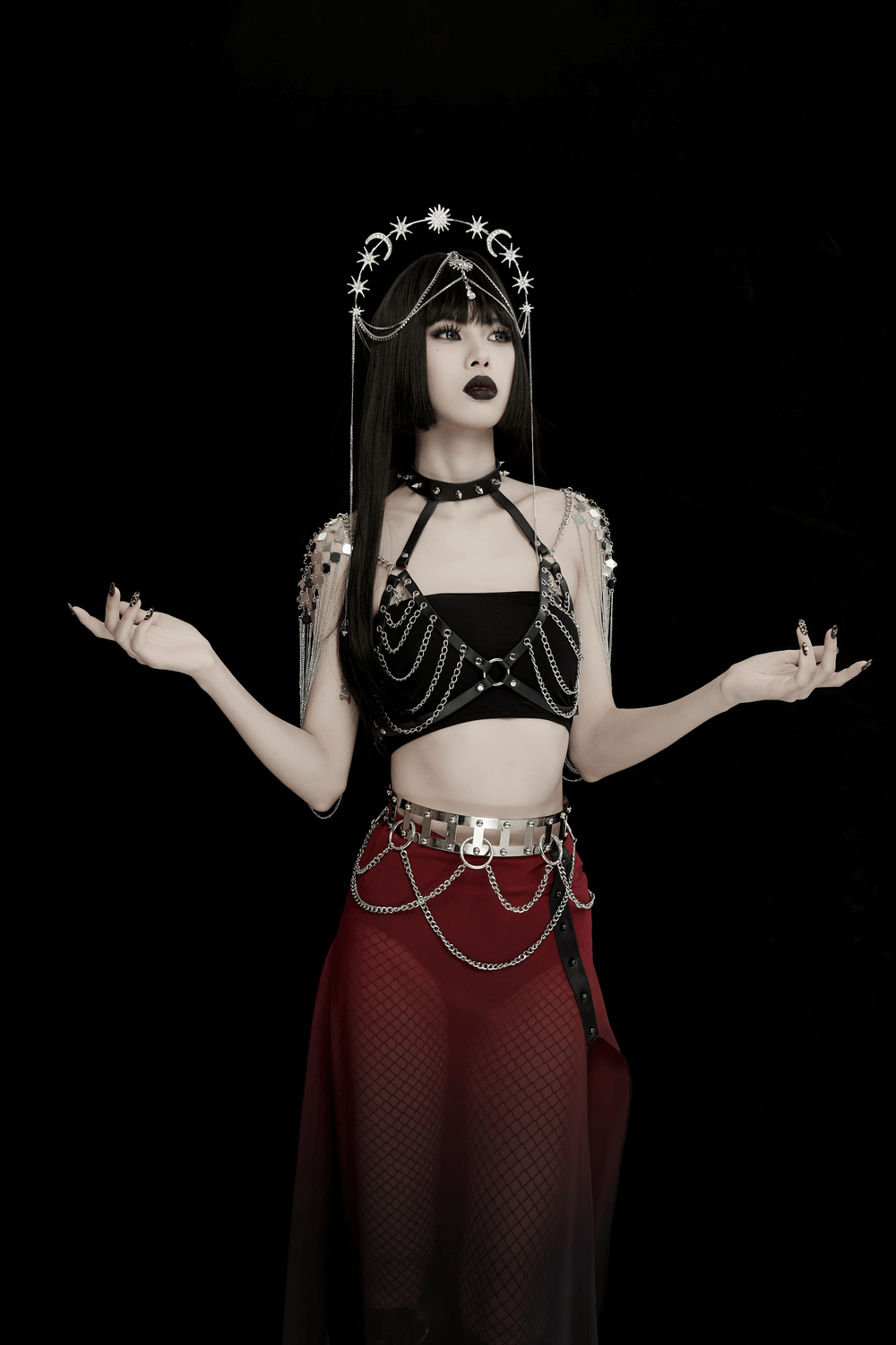Celestial Gothic headpiece with moon and star designs, worn by model in black and red attire, exuding mystical charm.