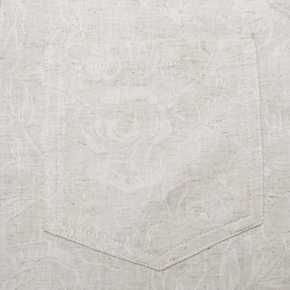 Close-up of pocket on a men's gothic linen shirt with intricate floral texture and artisanal craftsmanship.