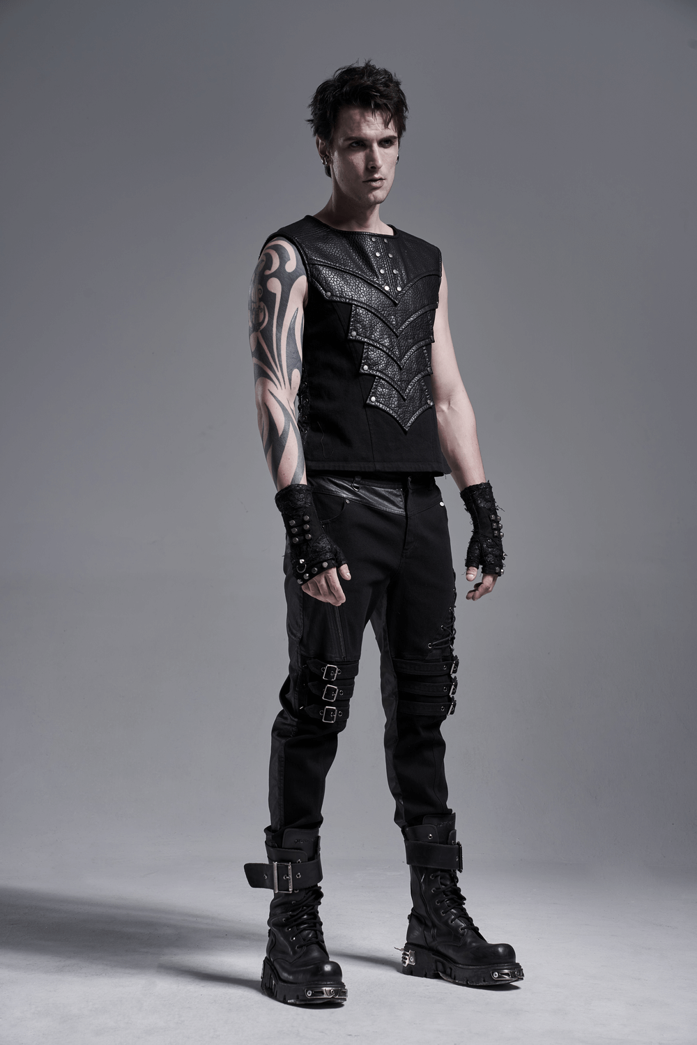 Stylish chest protector vest with adjustable side lacing, paired with edgy black pants and accessories for a bold look.