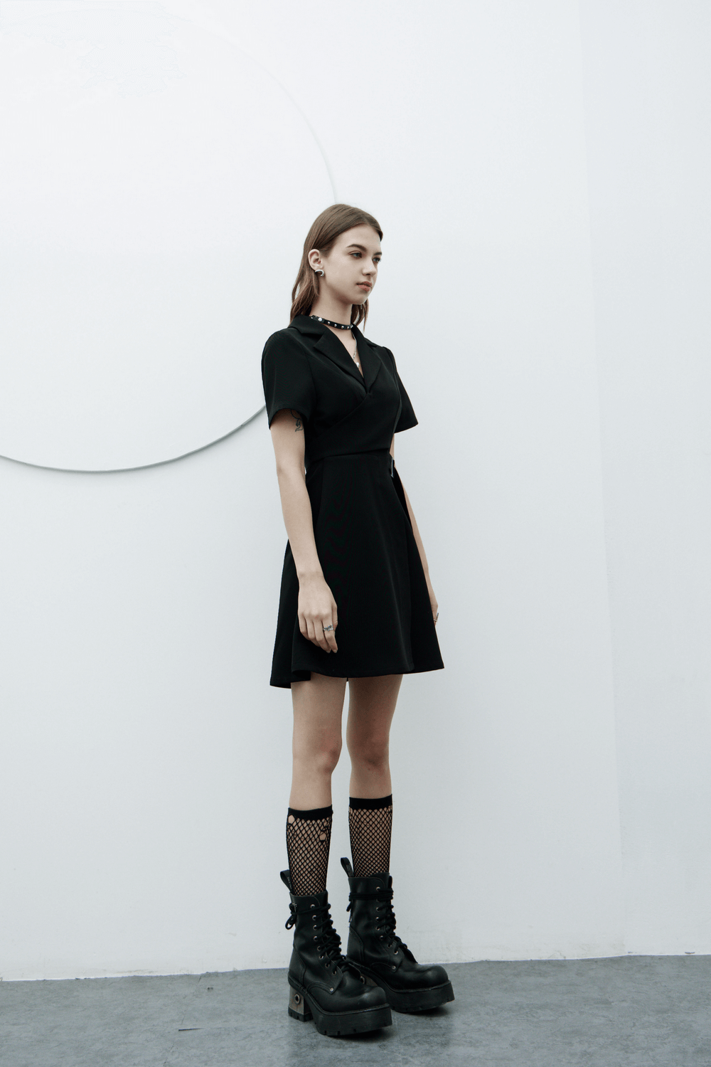 Chic A-Line dress with buckle detail, flared skirt, and stylish combat boots, showcasing modern elegance.