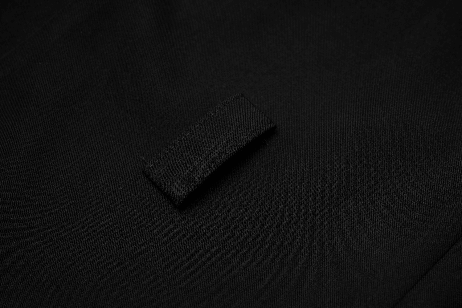 Close-up of a sleek black fabric with a stylish buckle detail on an elegant A-Line dress.