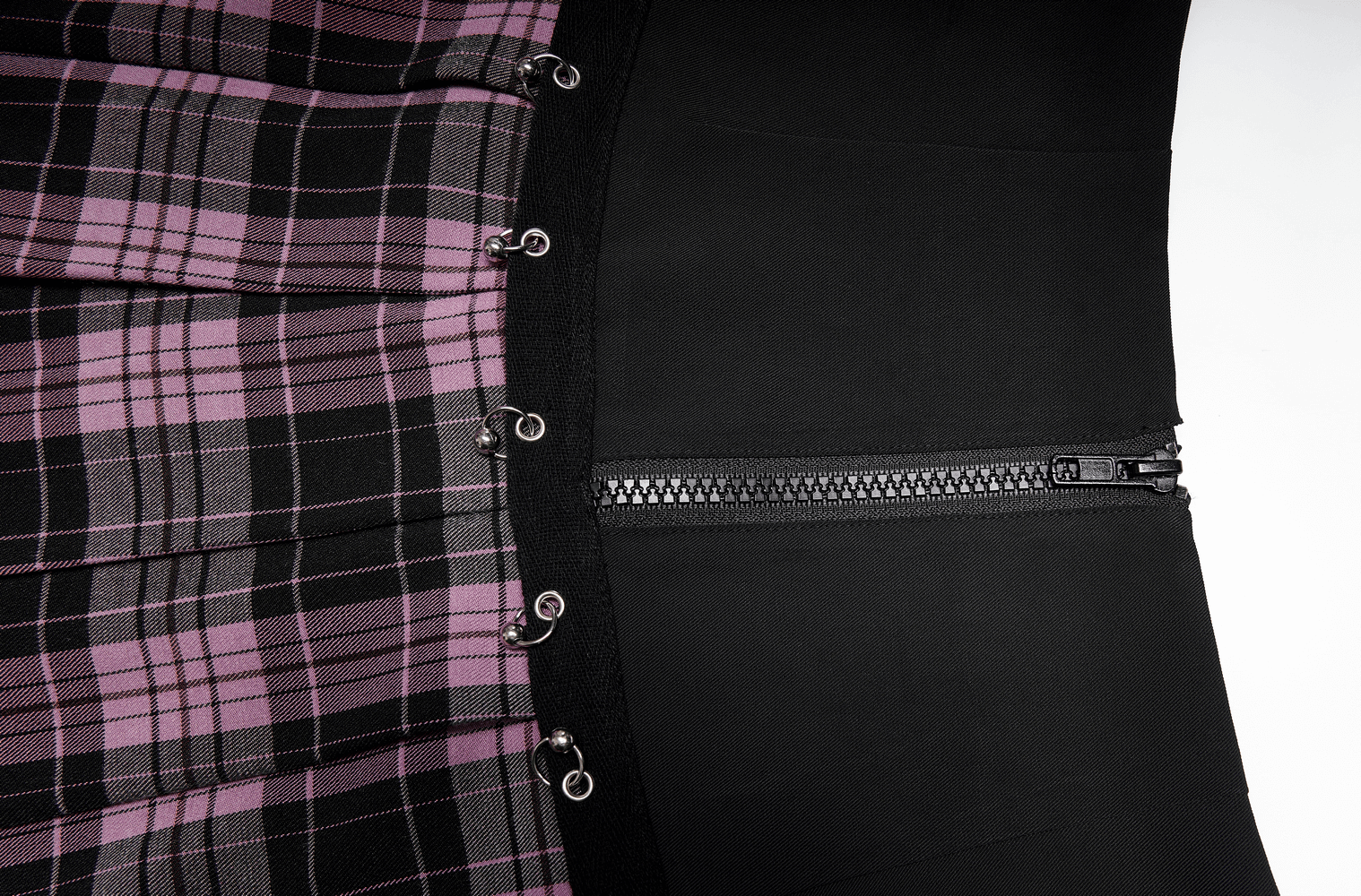 Chic A-line plaid skirt featuring metal ring accents and zipper detail for stylish flair.