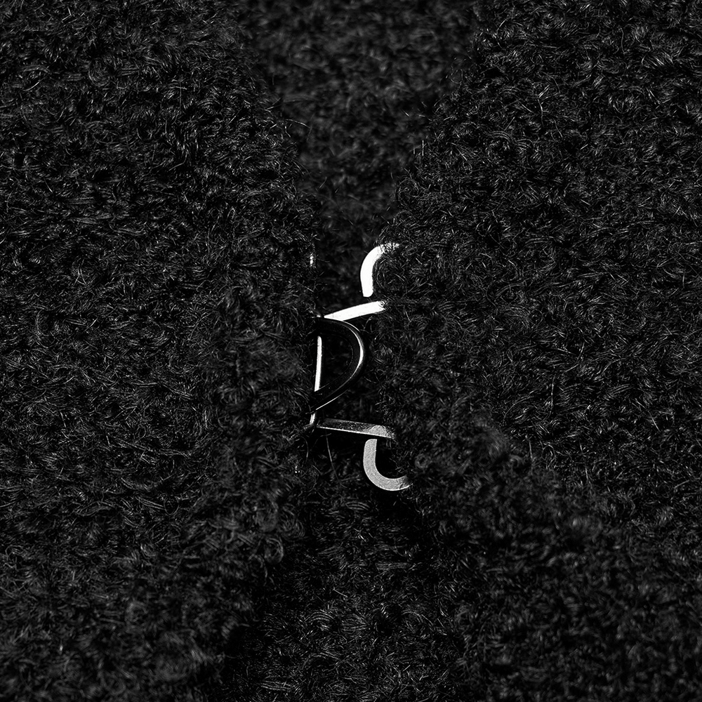 Close-up of the clasp on a chic black wool-blend cardigan, highlighting its stylish and cozy texture.