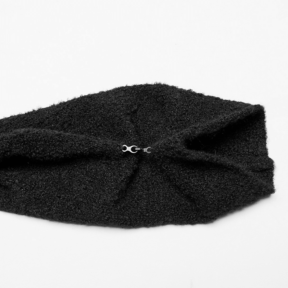 Close-up of a chic black headband with a stylish twisted design and a small clasp, perfect for winter accessories.