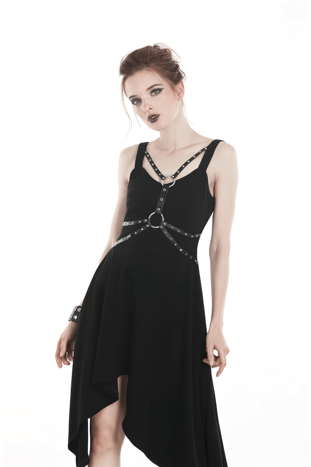Chic black asymmetrical dress with strap and chain detailing, exuding elegance and edgy style for evening events.