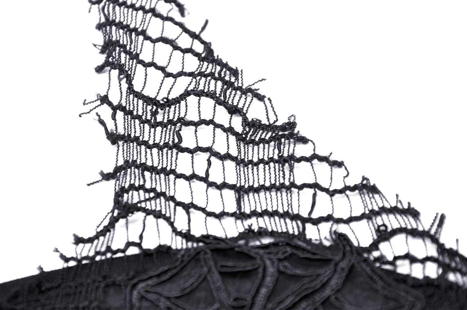 Close-up of black lace fabric featuring intricate netting details and frayed edges, perfect for a chic asymmetrical top.