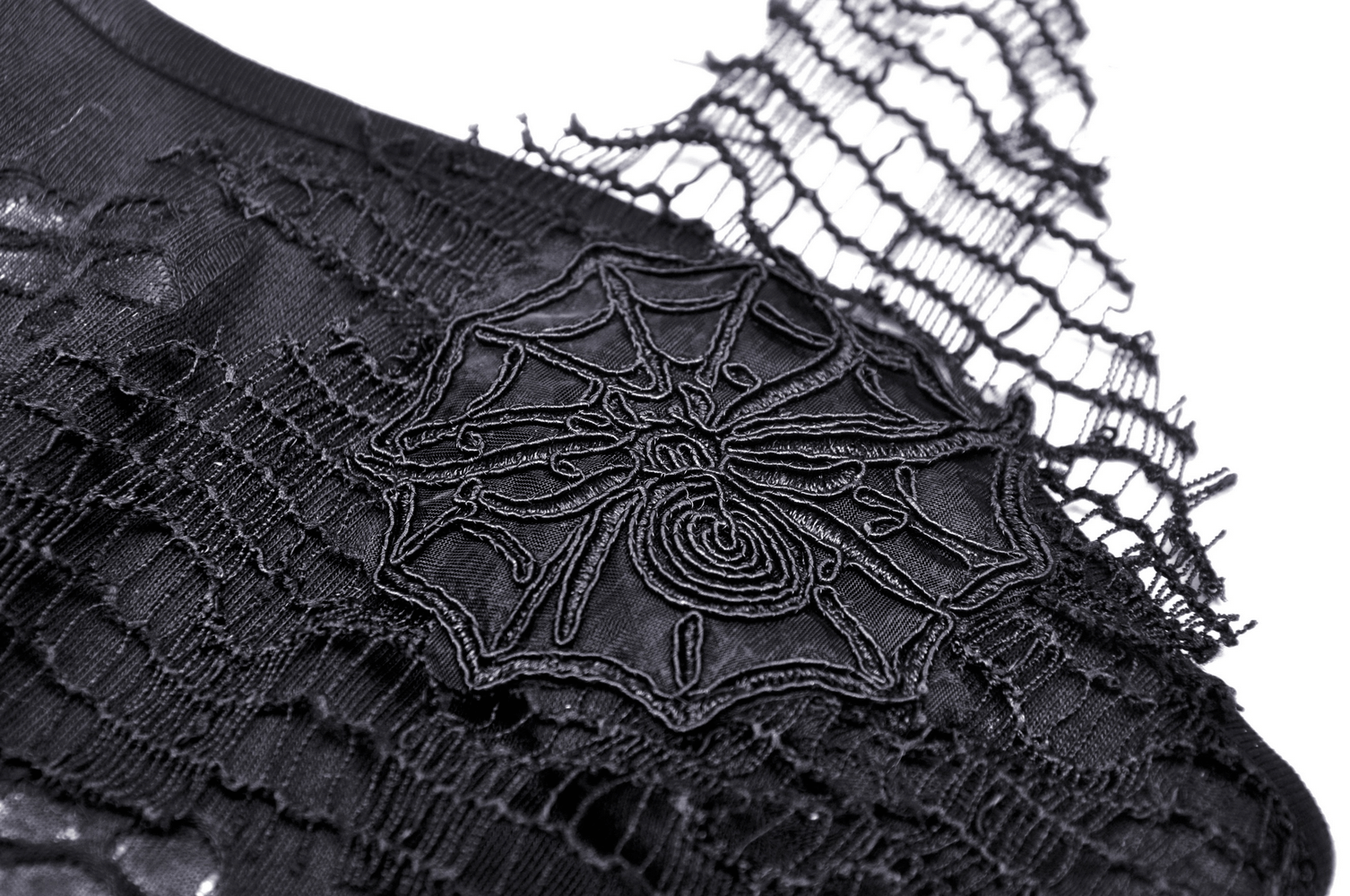 Close-up of black lace fabric featuring spider web design, adding elegance to chic halter top.