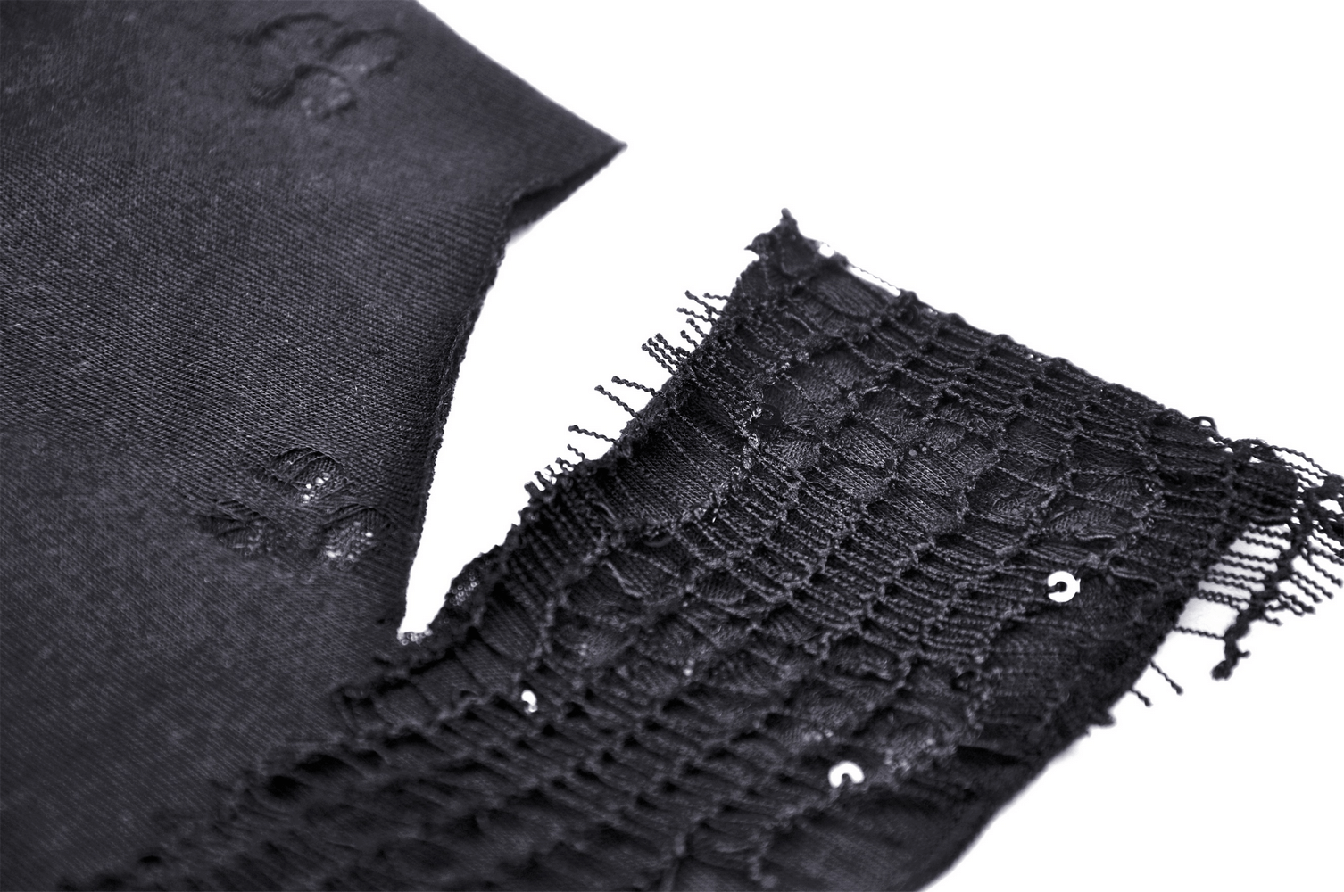 Close-up of black lace and fabric showcasing the texture of a chic asymmetrical halter top.