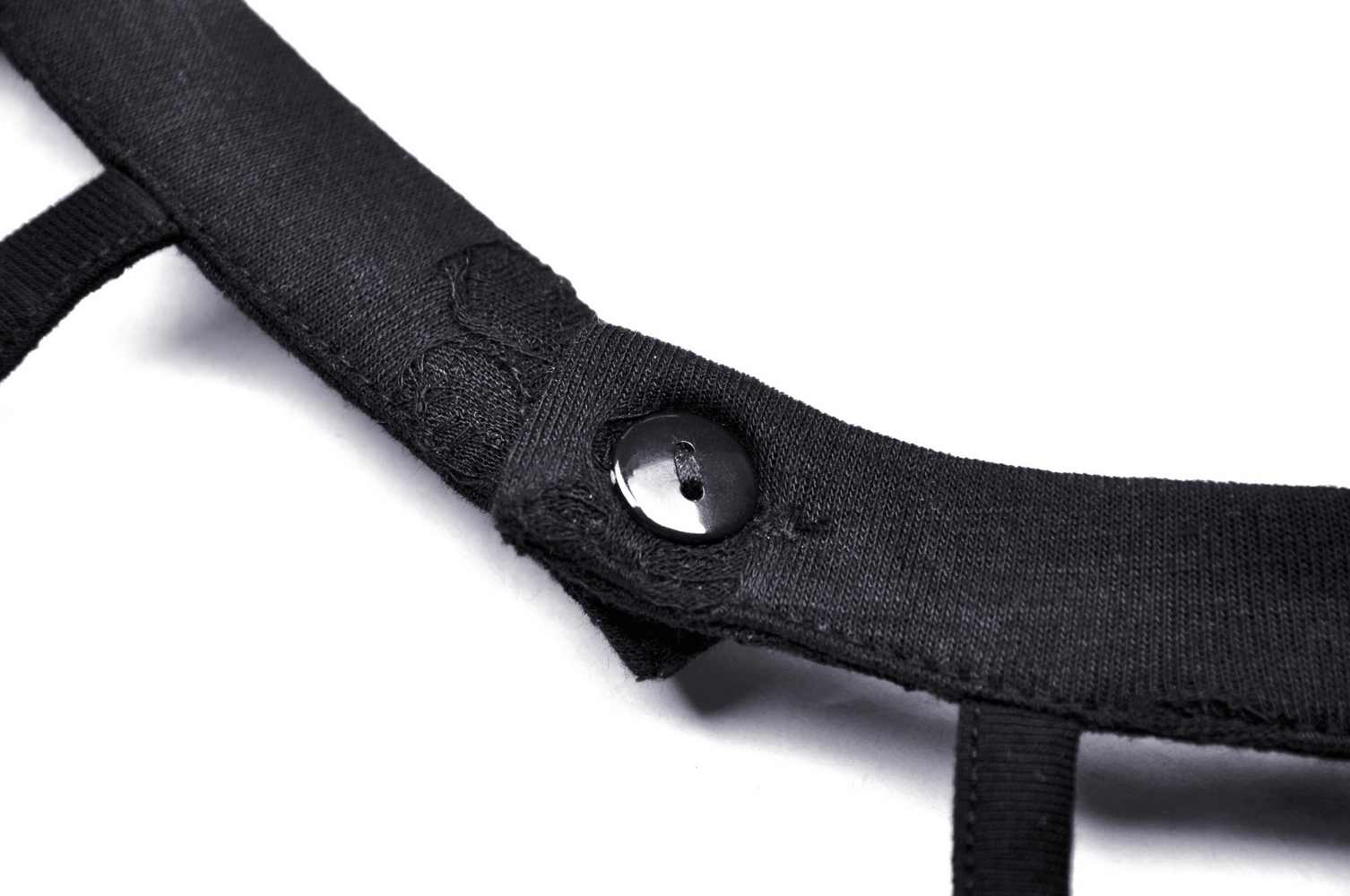 Close-up of black lace halter top strap with button detail, showcasing chic style and elegance.