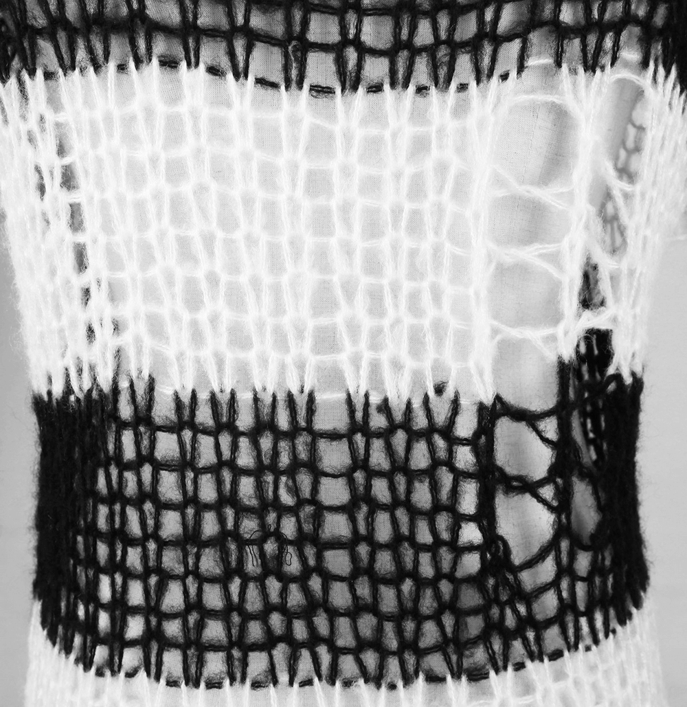 Close-up of a chic black and white striped knit sweater showcasing a unique holey texture.