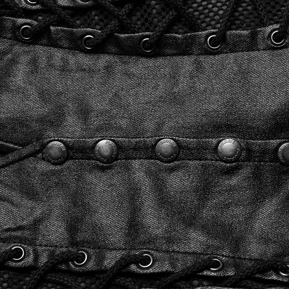 Close-up of chic black asymmetric top featuring metal accents and eyelet details for a trendy look.