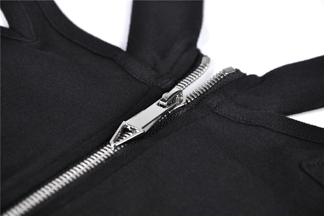 Close-up of a sleek black dress zip detail, showcasing precision and style for edgy fashion lovers.