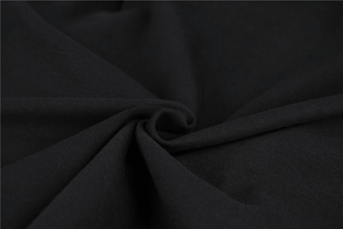 Close-up of chic black fabric showcasing soft texture, perfect for the edgy cut-out long sleeves lace-up dress.