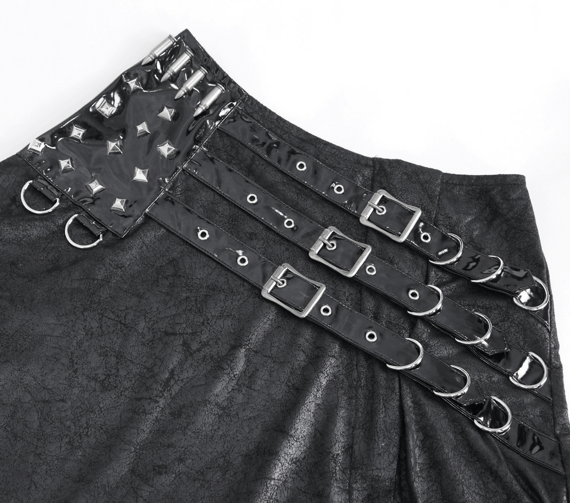 Close-up of a chic black faux leather long skirt featuring buckles and spikes, perfect for a gothic fashion statement.