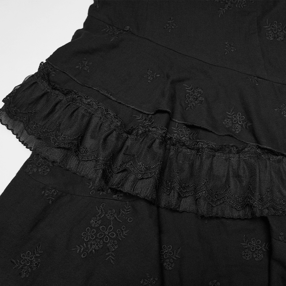 Chic Black Gothic Asymmetrical Lace Ruffle Slip Dress close-up of embroidered black fabric with layered ruffle hem and lace trim