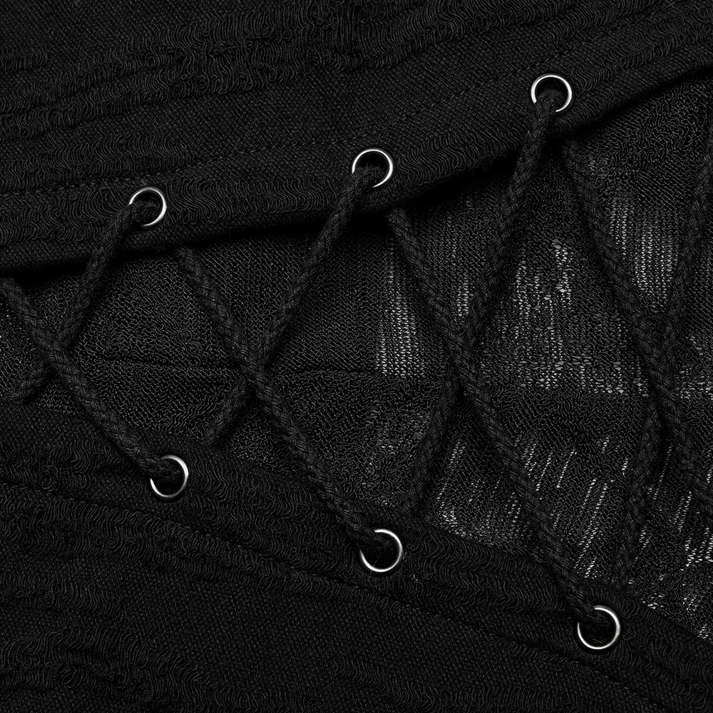 Close-up of the intricate black fabric and lacing detail on a gothic long coat.