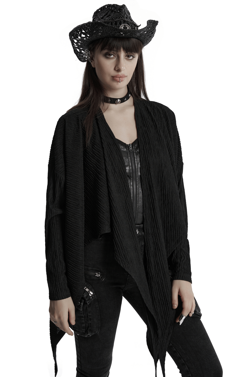 Chic black knit fashion cape for women, styled with punk accessories and a cowboy hat.