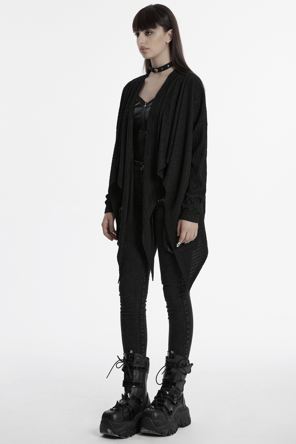 Chic black knit fashion cape for women, showcasing punk style with a sleek design and unique irregular hem.