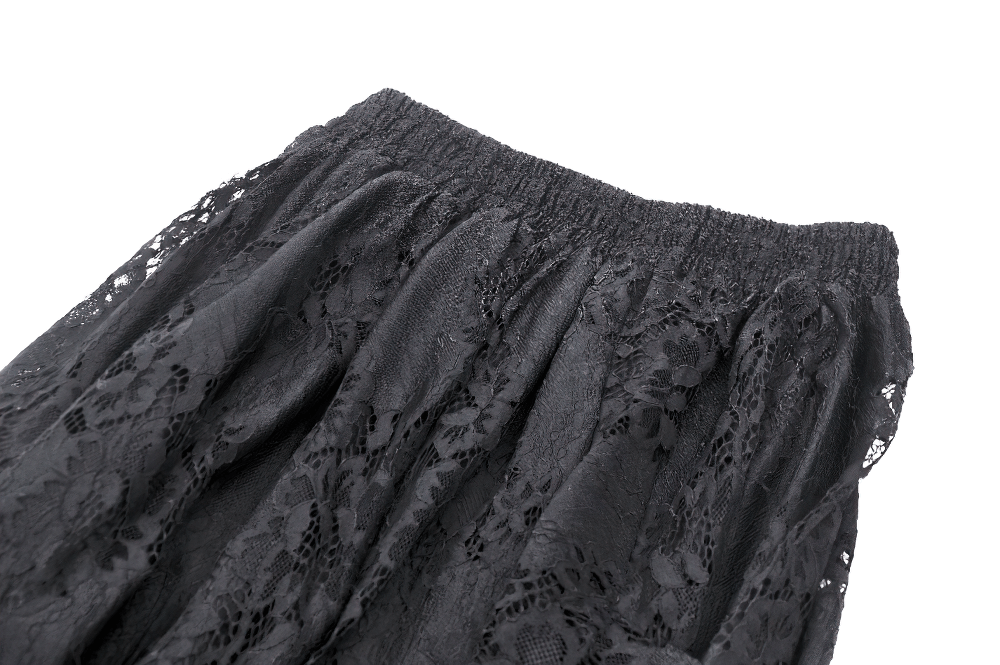 Close-up of black lace fabric featuring intricate floral patterns and elastic waistband for a gothic skirt.