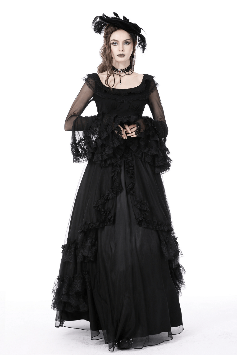 Elegant woman in a black lace gothic dress with sheer sleeves and ruffled details, showcasing a dramatic, romantic style.
