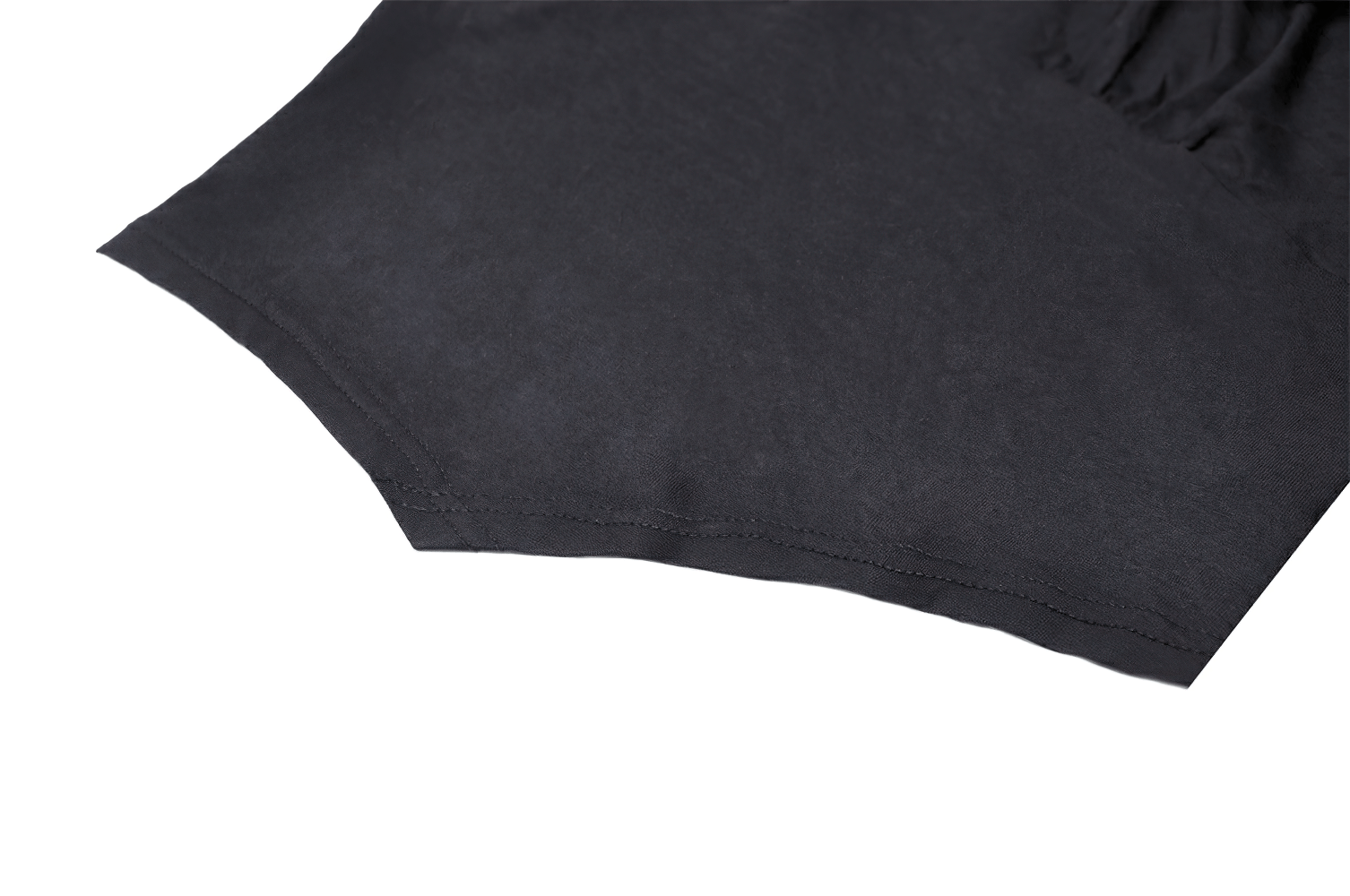 Close-up view of the hem of a chic black lace bell-sleeved top with sheer mesh detail.