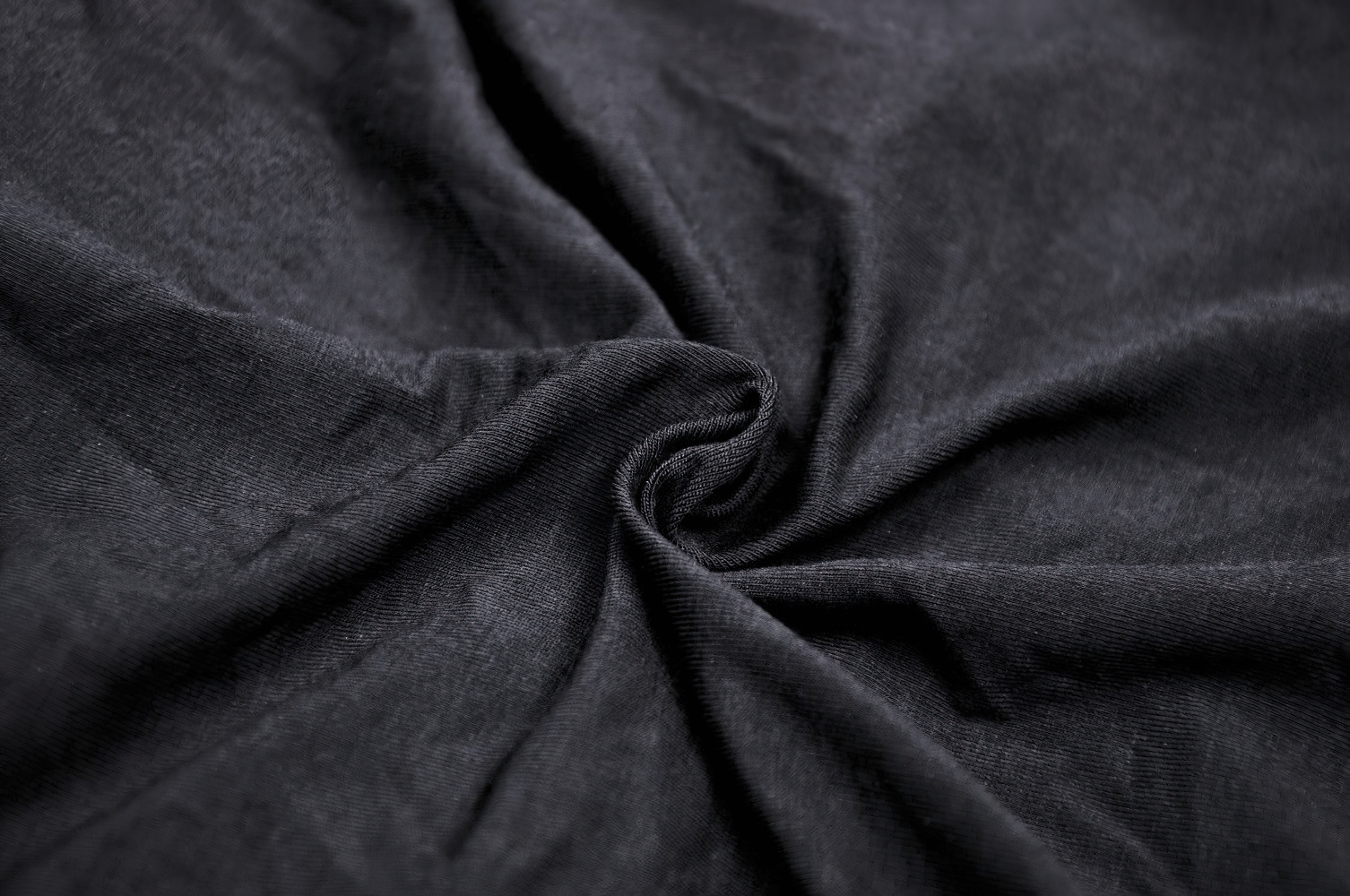 Close-up of soft, black fabric showcasing a rich texture, perfect for stylish clothing designs.