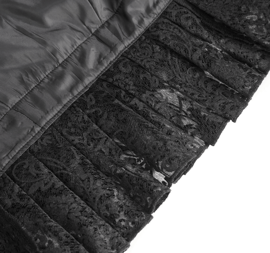 Close-up of a chic black lace bolero showcasing intricate lace detailing and elegant ruffle trim.