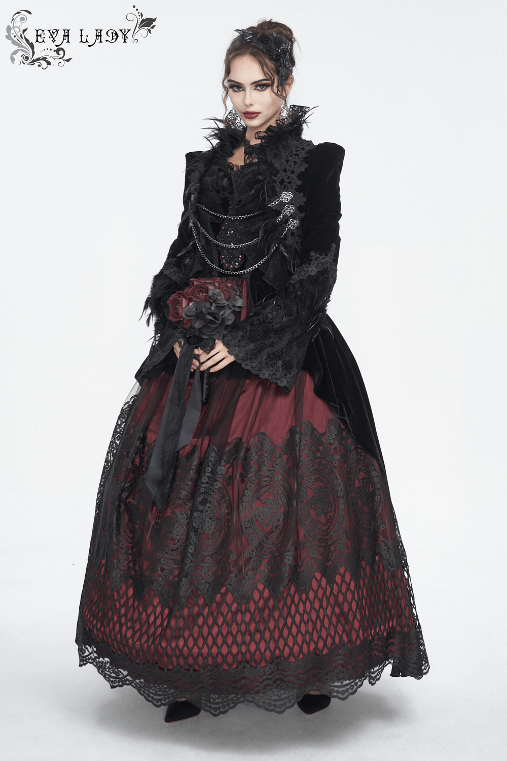 Gothic fashionista in a black and red Victorian-inspired dress with lace and chain accents.