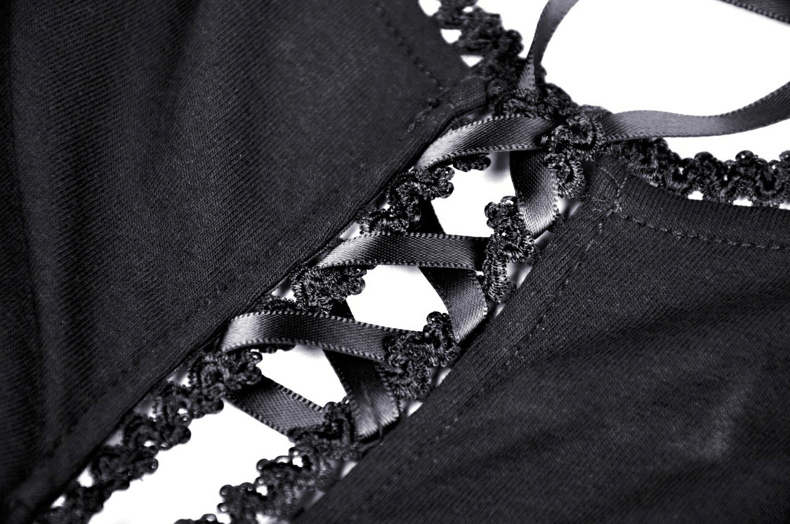 Close-up of black lace-up detail and sheer fabric on a chic dress, showcasing elegant design and modern style.