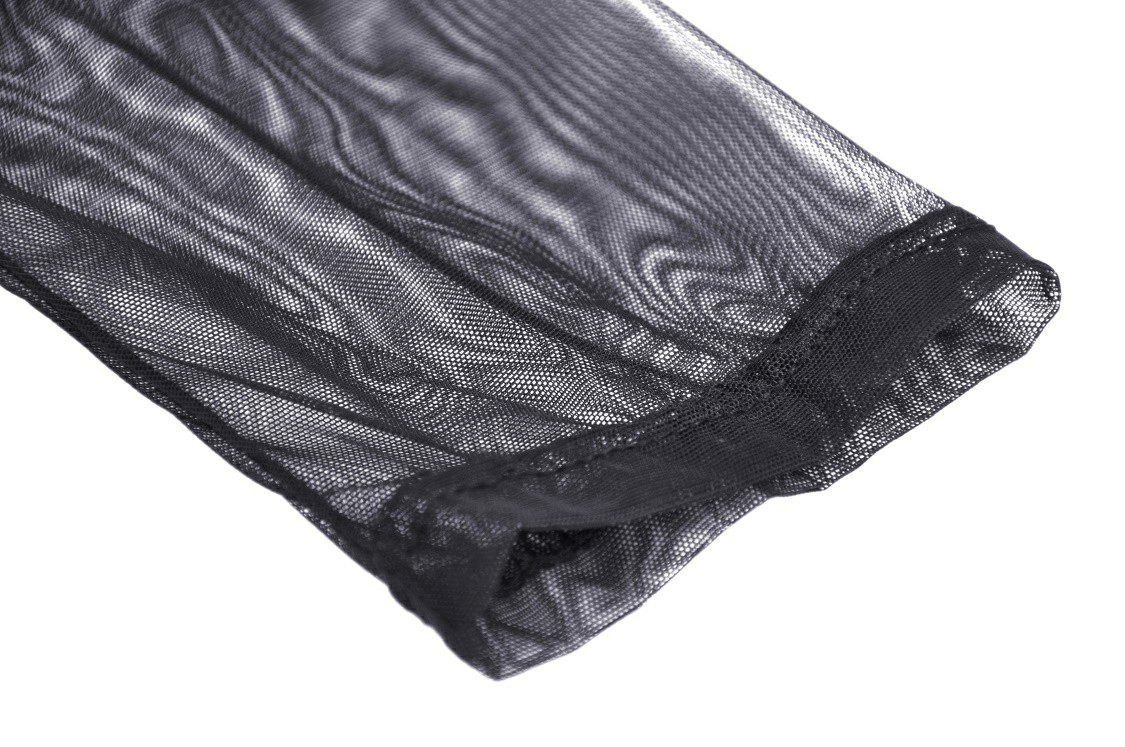 Close-up of sheer black mesh fabric detailing from a stylish mini dress.