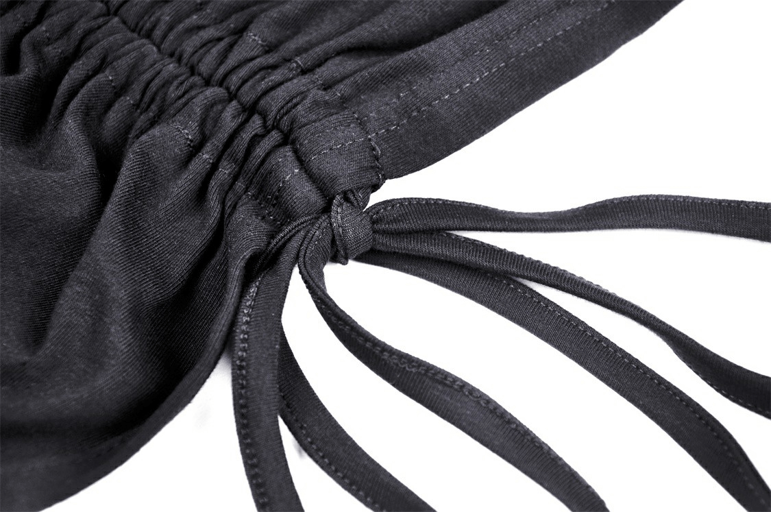 Close-up of black lace-up detail and gathered fabric for chic mini dress, showcasing stylish ties and texture.