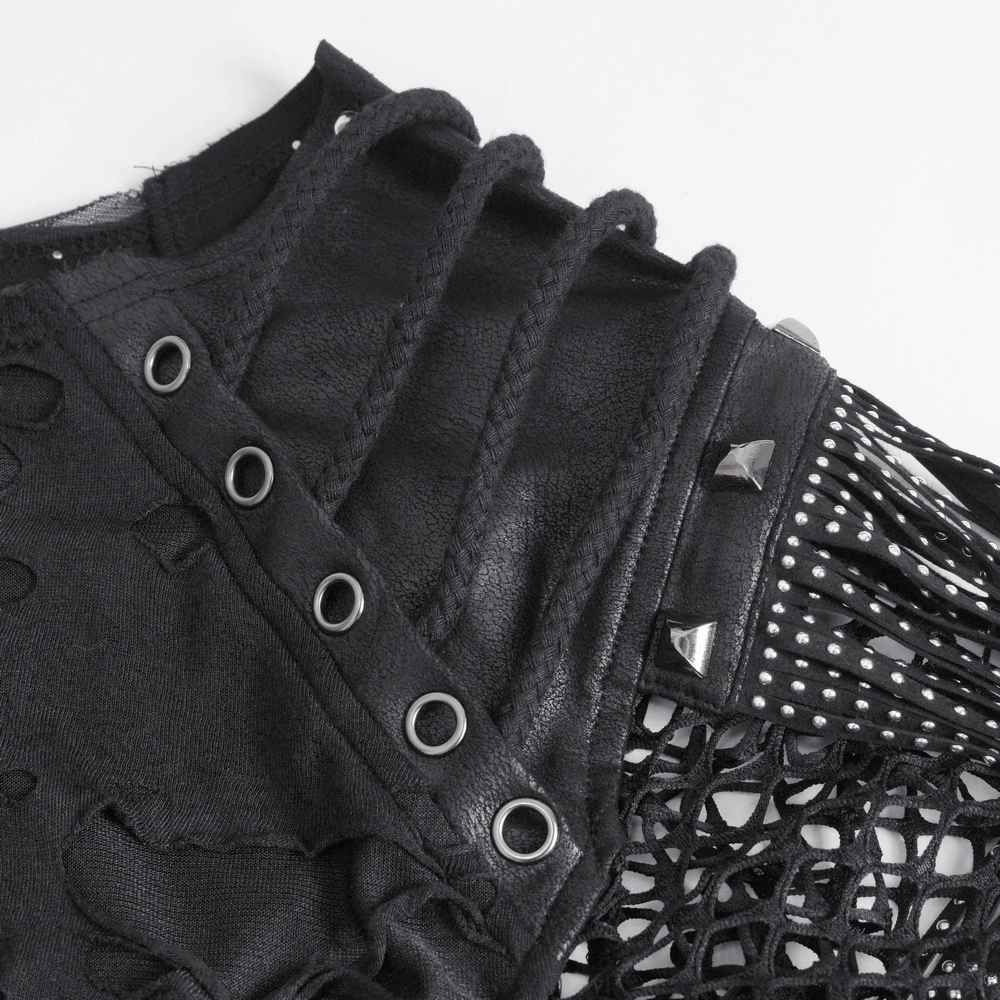Close-up of black mesh t-shirt showing fringe details, silver studs, and edgy design elements.