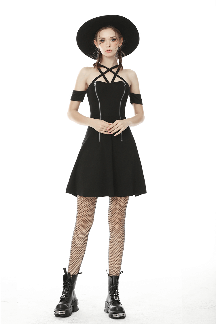 Chic black off-shoulder A-line dress with cross straps, stylishly paired with a hat and fishnet stockings.