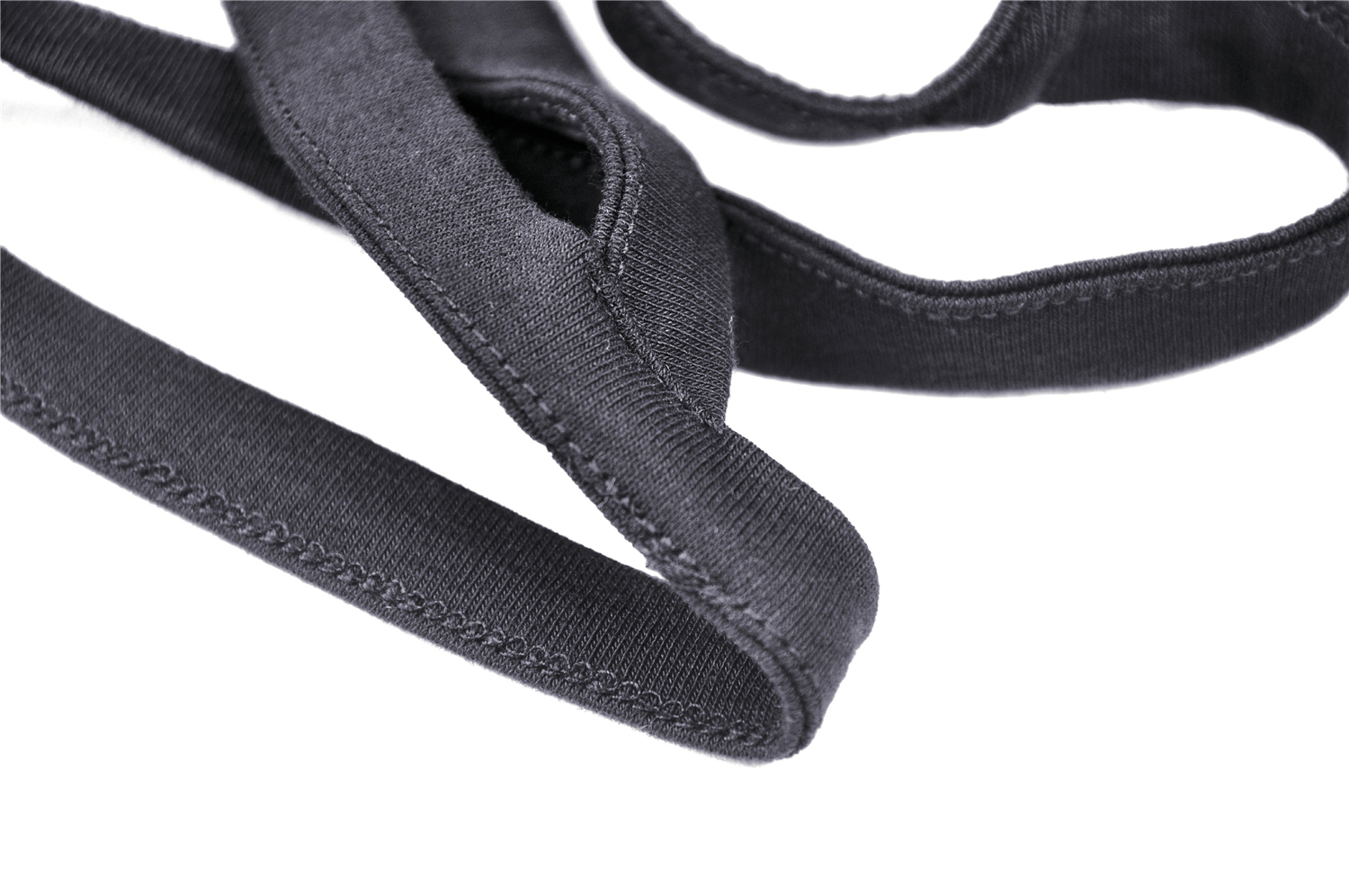 Close-up of stylish black cross straps ideal for off-shoulder dresses, showcasing their soft fabric and sleek design.