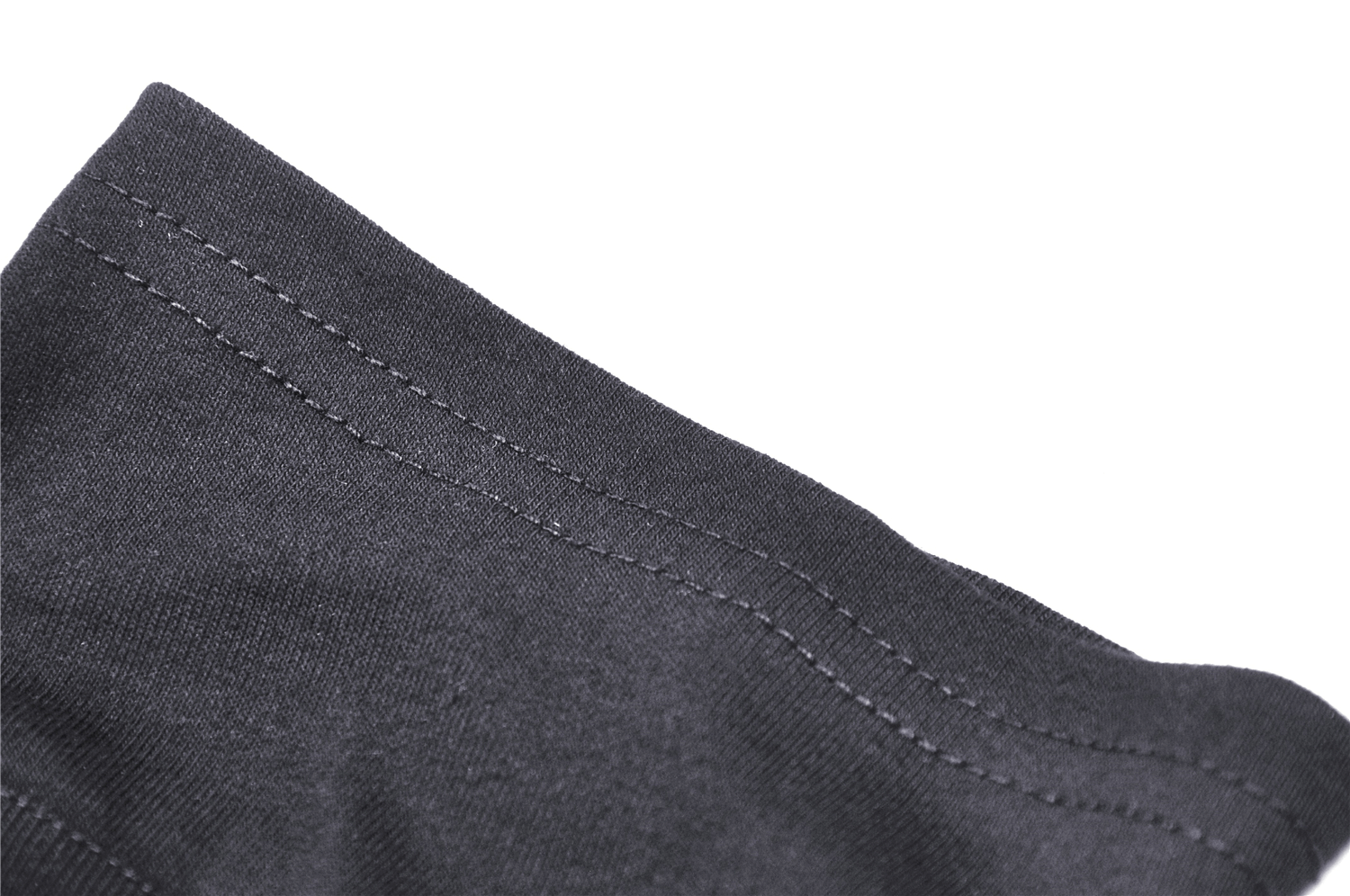 Close-up of black fabric hem showcasing neat stitching and quality craftsmanship.