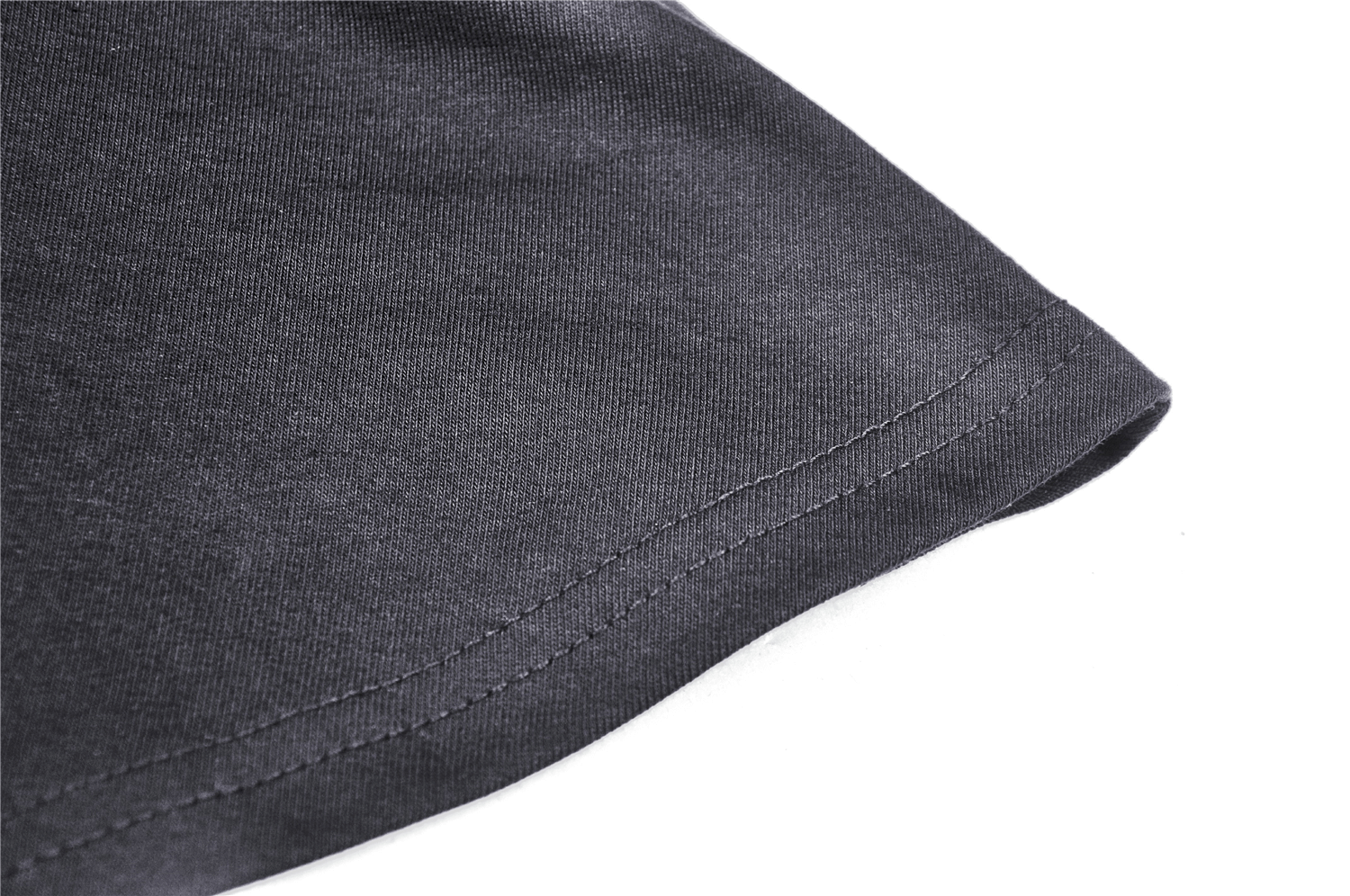 Close-up of the hemline of a chic black fabric showing detailed stitching and smooth texture.