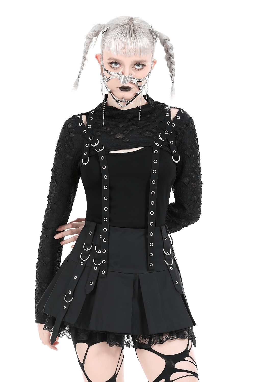 Chic black ripped crop top with metal accents, paired with a stylish skirt for a bold fashion statement.