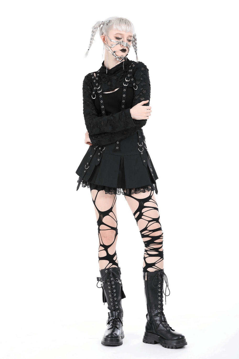 Chic black ripped crop top with metal accents and edgy lace-up leggings, perfect for a bold fashion statement.