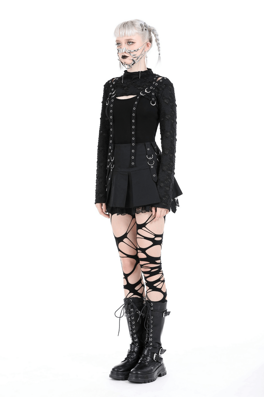 Chic black ripped crop top with metal accents, paired with edgy lace-up stockings and combat boots for a bold fashion statement.